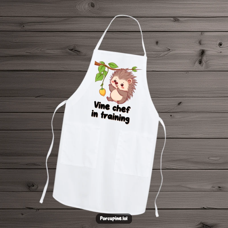 Funny apron showcasing a kawaii porcupine playfully batting at a dangling vine, perfect for a humorous kitchen assistant.