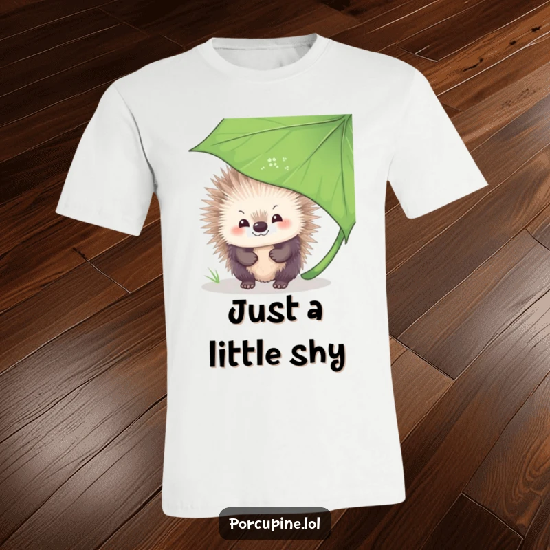 Funny T-Shirt featuring a porcupine peeking from behind a large leaf, offering a shy, heartwarming smile to the viewer.