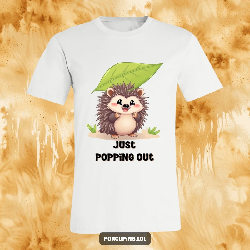 Funny t-shirt with a porcupine peeking from behind a large leaf with a grin, designed to bring smiles and playful charm to the wearer.