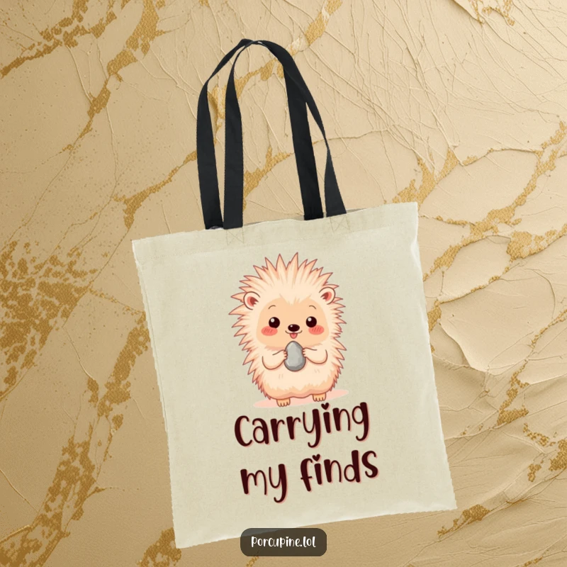 Funny tote bag depicting a happy porcupine proudly presenting a single, shiny pebble, perfect for carrying with heartwarming flair.