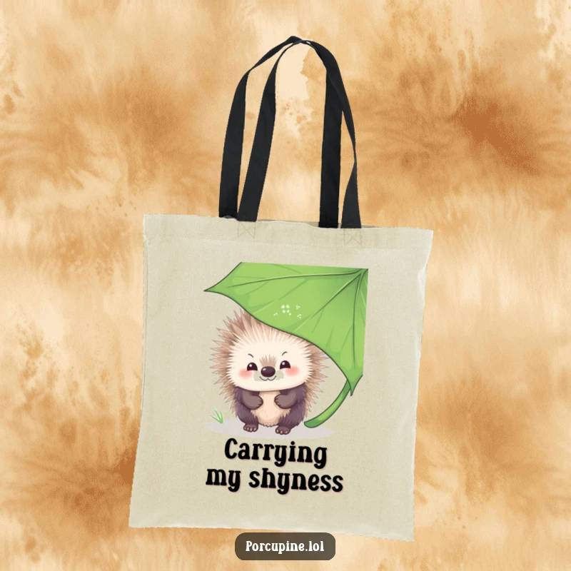 Funny Tote Bag featuring a porcupine with a shy smile, peeking out from behind a large leaf, conveying a sense of gentle playfulness.